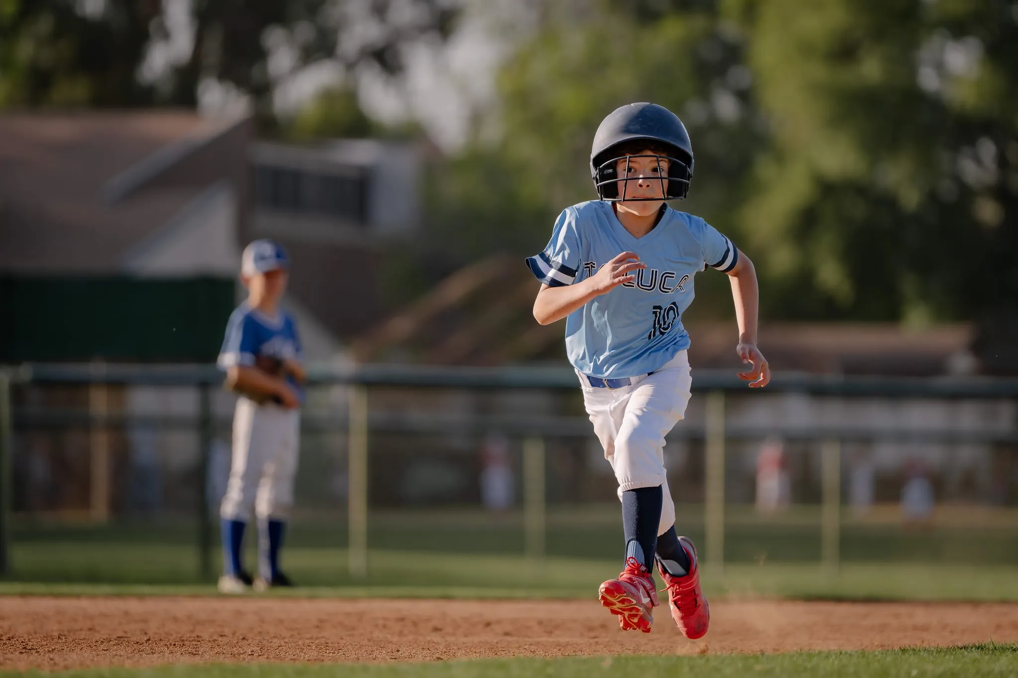 Helmeted runner charges down the line, focused, the defense blurred behind